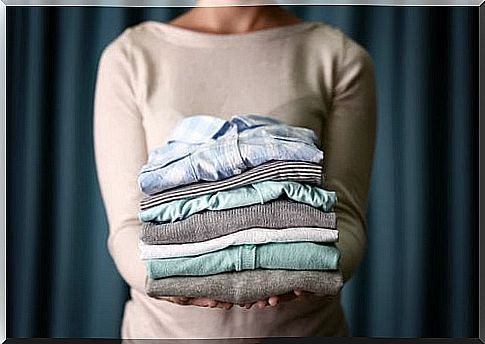 Woman standing with folded clothes