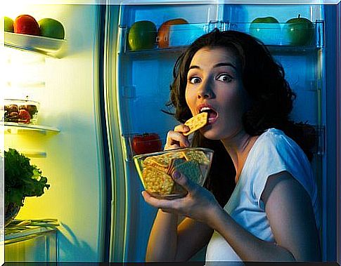 Woman snacking from the fridge