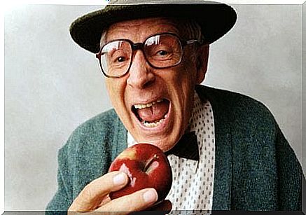 Elderly gentleman eating an apple