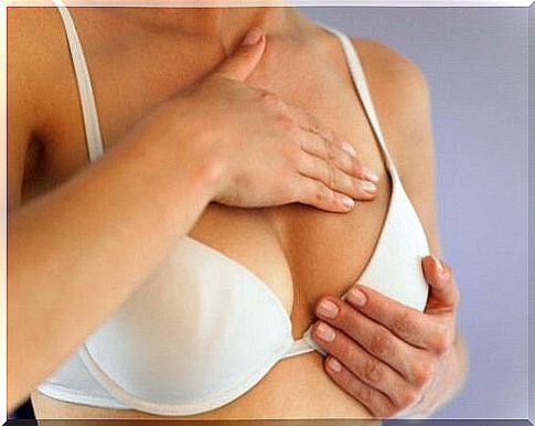 Woman examining her breast