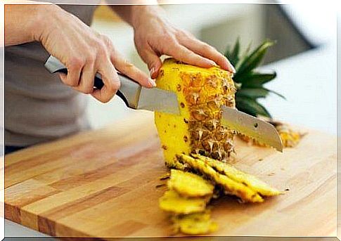 woman cuts out pineapple