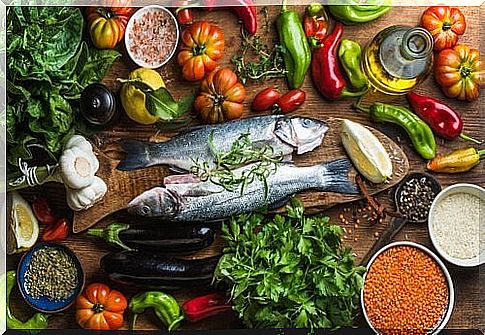 Fresh fish and vegetables on a table.