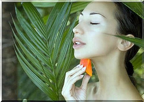 Woman with papaya in the jungle