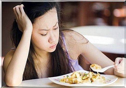 Woman staring at her food - gallbladder problems