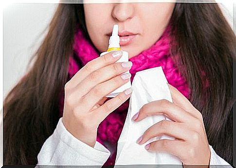 Woman using nasal spray against a stuffy nose