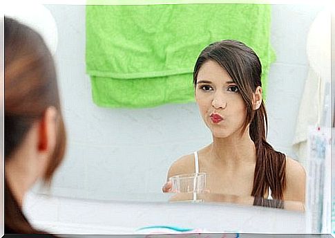 Young woman looking at herself in the mirror