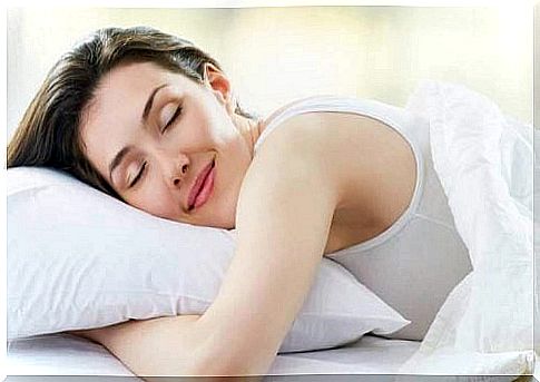 Woman smiling while huns lying with her pillow