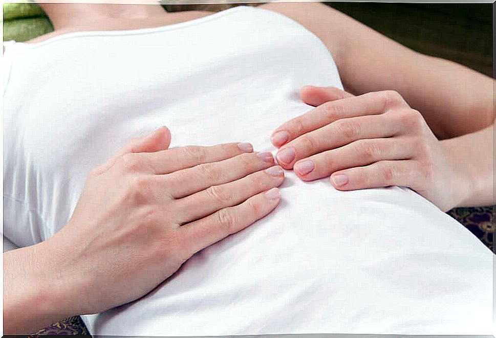 Woman lying and holding on to her stomach