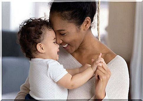 Smiling mother with baby in her arms