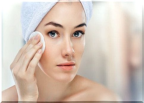 Woman cleansing her skin - washing your face