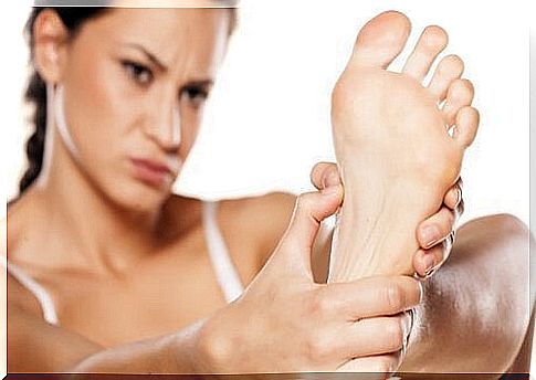 Woman holding her foot.