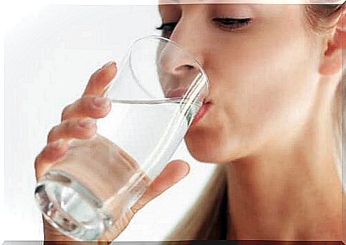 A woman drinking a glass of water