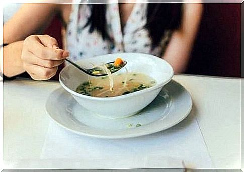 Woman eating soup