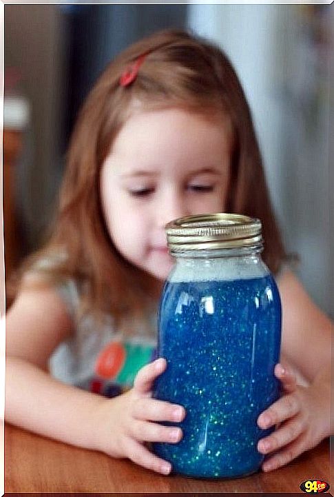 Girl looking at glitter jar