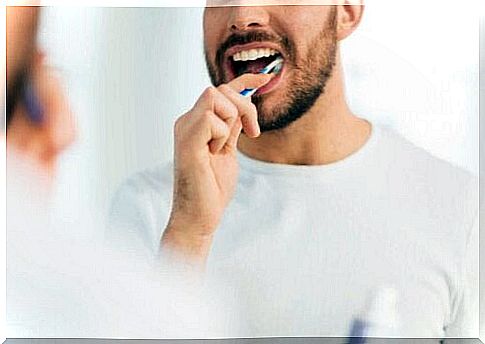 Man brushes teeth