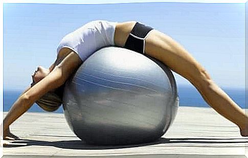 Woman on big ball practicing pilates