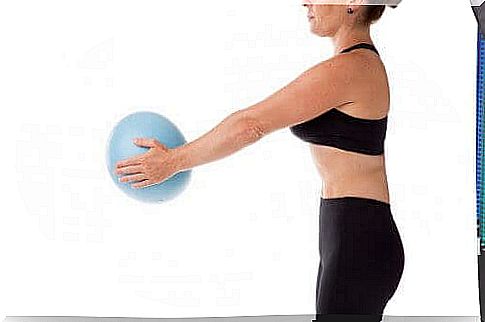 Woman with ball practicing pilates during pregnancy