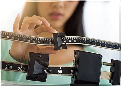 Woman standing on an analog scale