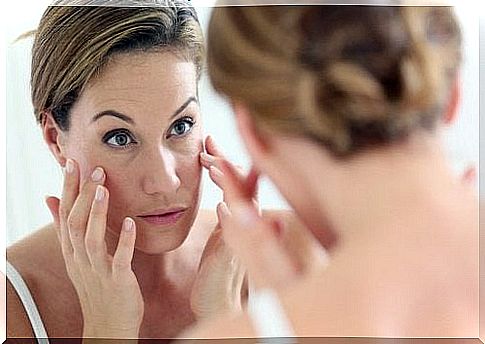 Woman looking at herself in the mirror