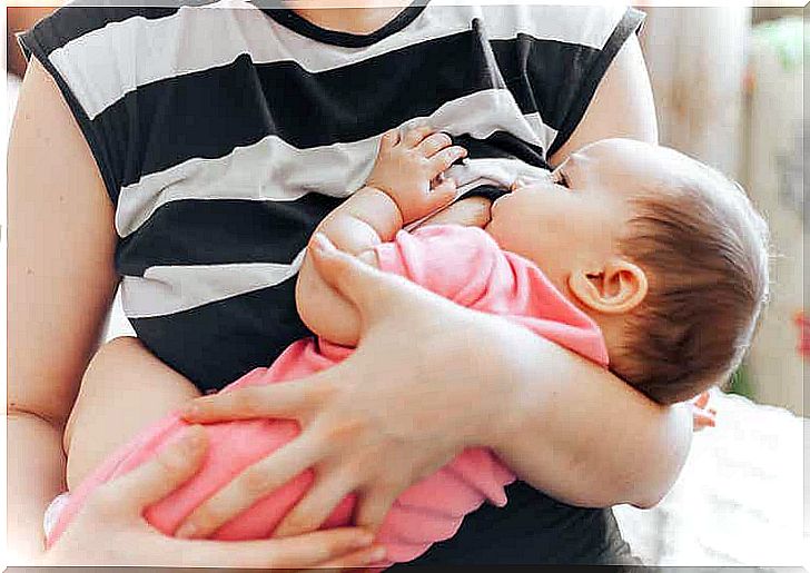 A baby staring at her mother's face while breastfeeding